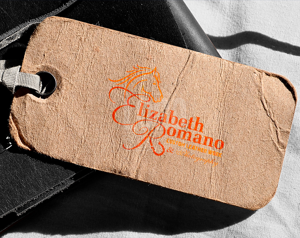 leather work logo design displayed on a cloths tag