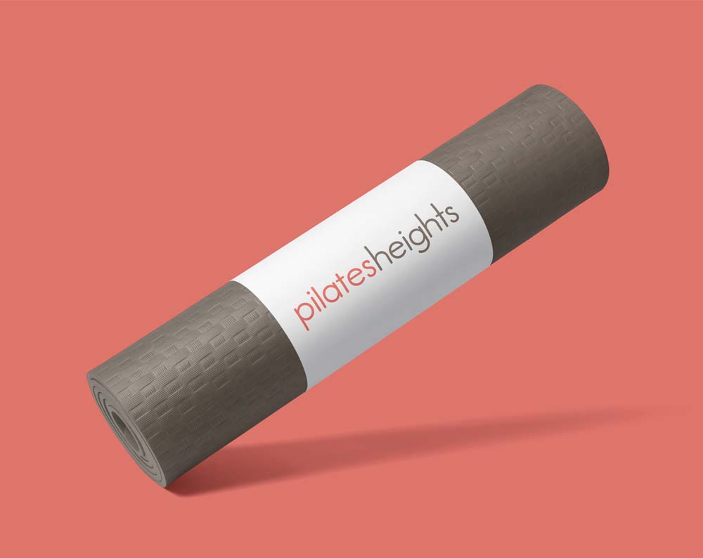 Professional and Creative Logos & Visual Branding for Pilates Studios: A rolled up pilates mat with custom logo design by Logo Design NYC