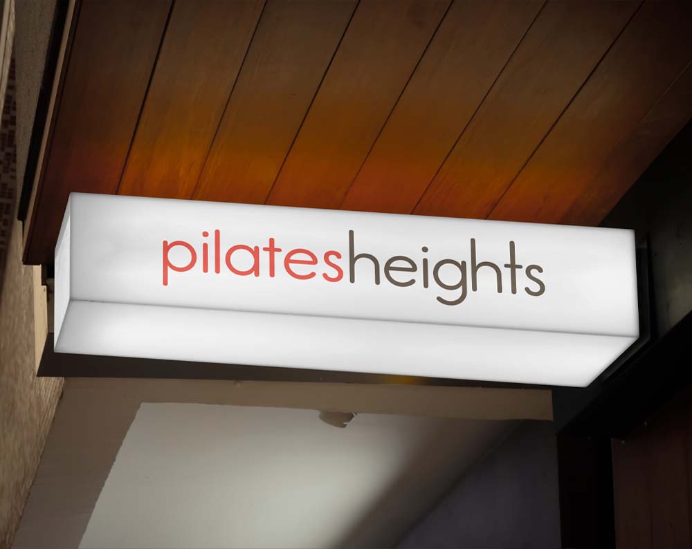 pilates logo design displayed on a store sign
