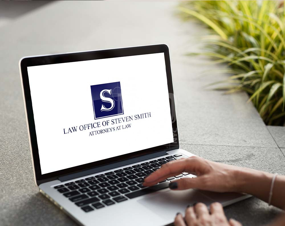 Law firm logo design displayed on a lap top