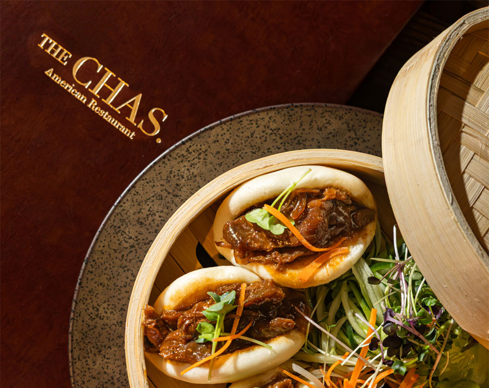 the Chas printed on a menu with a plate of food next to it